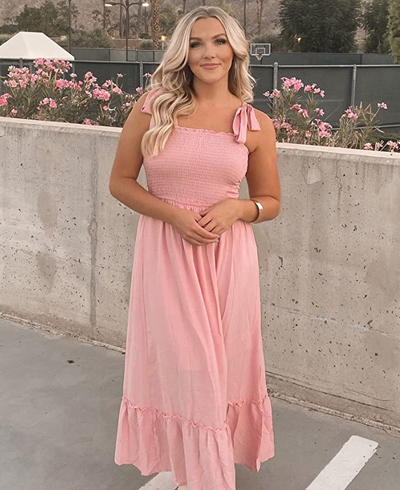 A reviewer wearing the pink dress