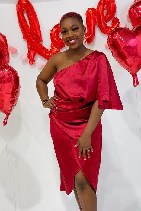 A reviewer in the red draped dress, sharing their experience with its fit, style, and overall appeal.