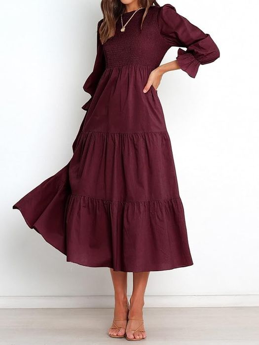 front view of a model in a red tiered midi dress