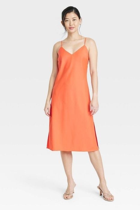 Model showcasing the orange dress