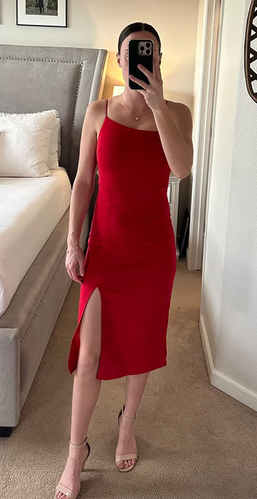 A reviewer showcasing the spaghetti strap red midi dress