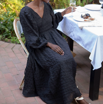 another model in the same dress styled with a V-neck