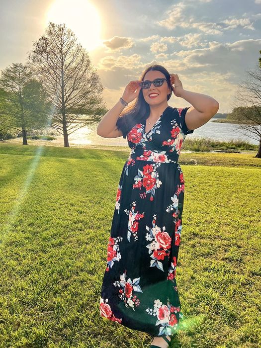 A reviewer wearing the floral dress