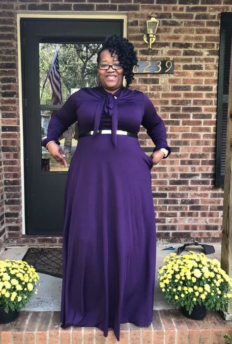 Another reviewer is dressed in a purple version of the dress, accessorized with a stylish belt.