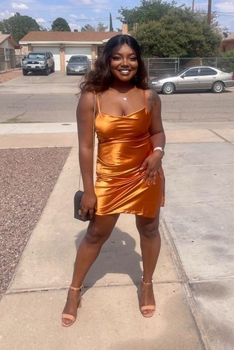 Reviewer showcasing the orange dress