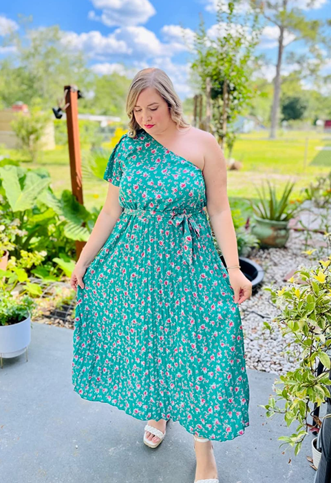 another reviewer showcasing the dress, highlighting its loose, pleated skirt