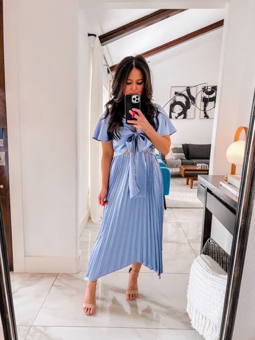 A reviewer is seen in the soft, serene shade of baby blue, showcasing the dress's elegance.