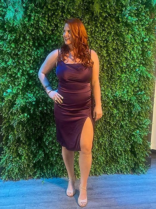 Reviewer showcasing the deep purple dress