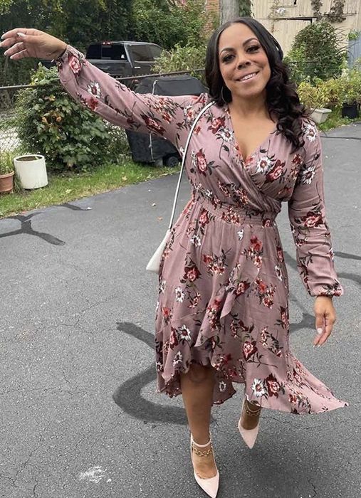 A reviewer wearing the dusty rose floral dress