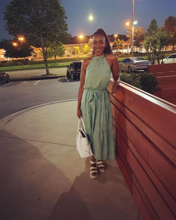 A reviewer wearing the mid-calf length light green dress with white polka dots