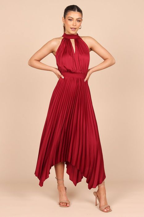 A model confidently showcases the dress in a bold red, making a statement with every step.
