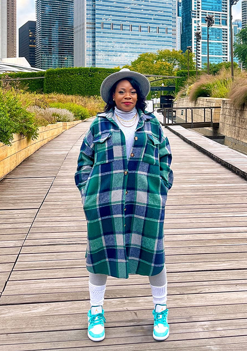 A reviewer showcasing the blue and green plaid dress