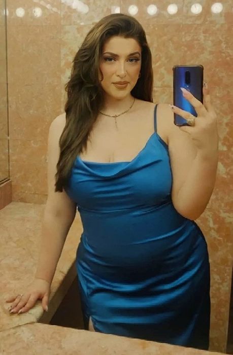 Reviewer wearing the teal blue dress