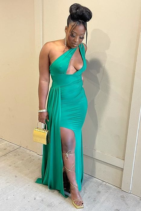 A reviewer wearing the green dress