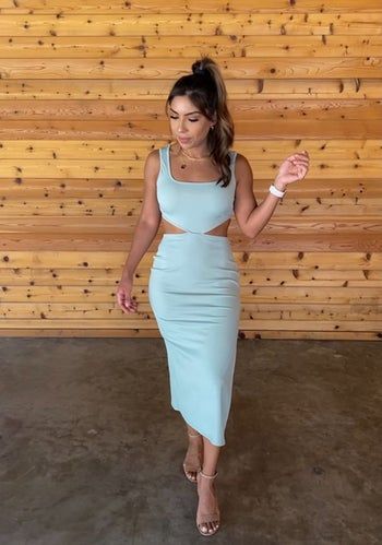 A reviewer is seen wearing the dress in a refreshing mint green shade.