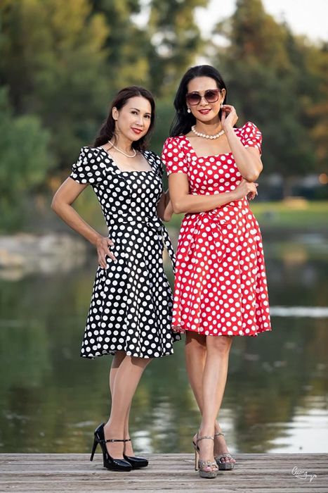 Reviewers showcasing the black, white, and red polka dot dresses