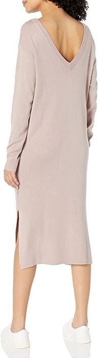 A model showing the V-shaped back of the beige dress