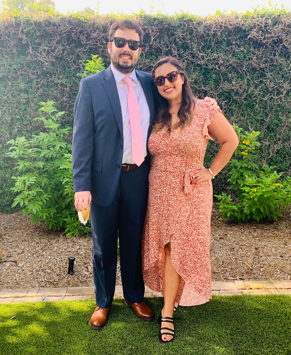 the writer wearing the orange dress paired with black heels