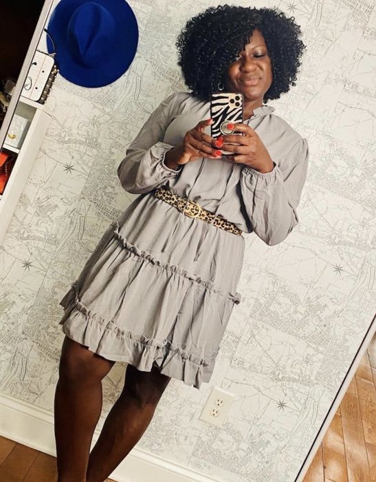 A reviewer wearing the grey dress