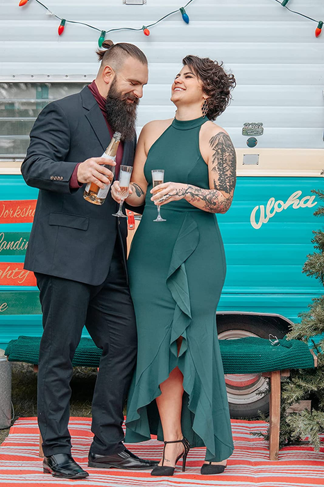 A reviewer showcasing the green gown with elegance.