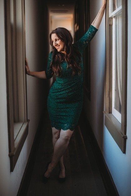 Reviewer showcasing the dark green dress