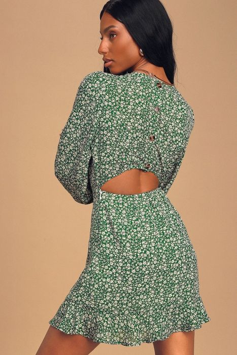 A model demonstrating the back view of the dress.