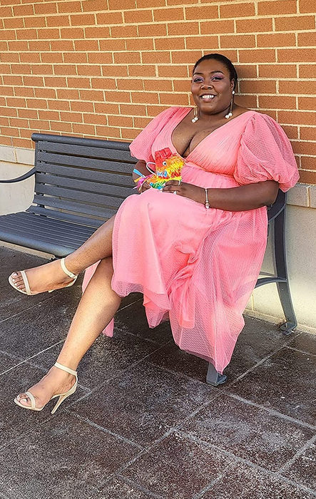 a reviewer seated in the pink dress