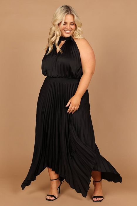 Another model poses in the classic black version, proving how versatile and chic this dress can be.