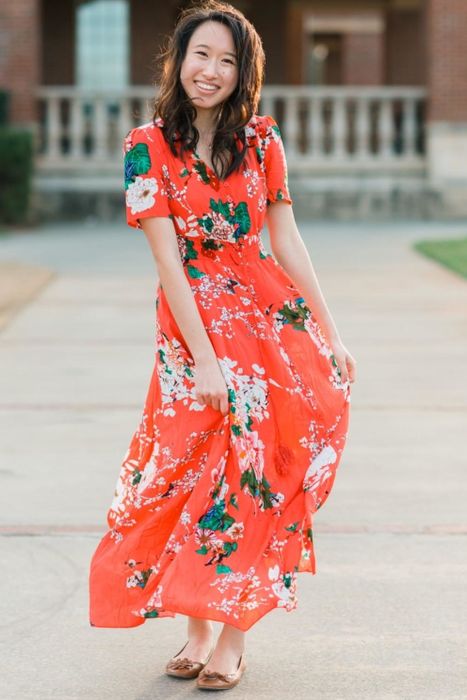 Reviewer modeling the coral red dress