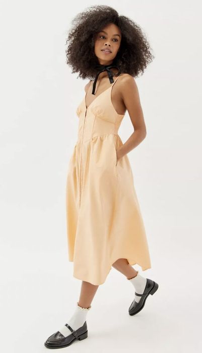 A model showcasing the orange dress
