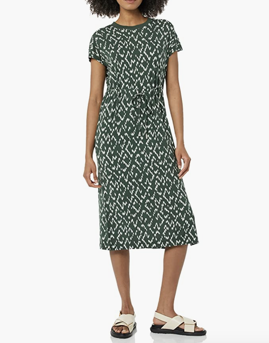 Model wearing a short-sleeve green dress with a drawstring waistband