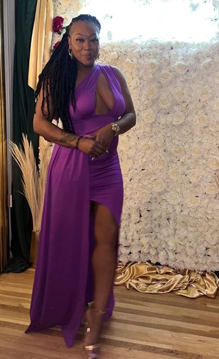 Reviewer showcasing the dark purple dress