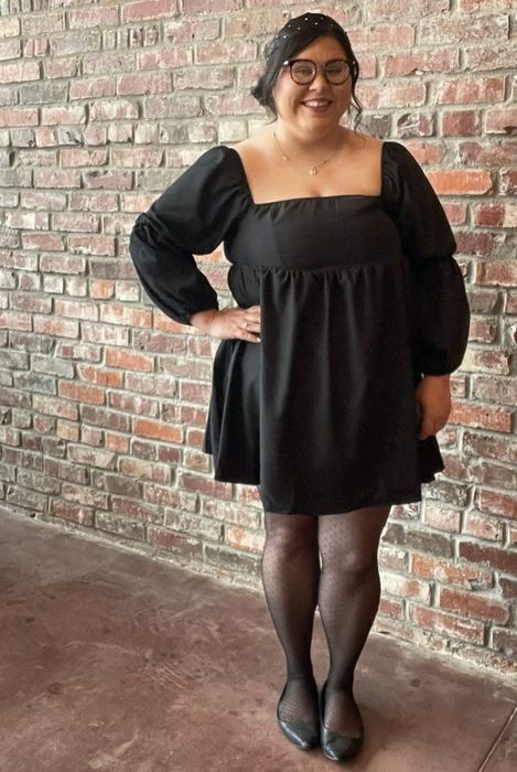 A reviewer wearing the black dress