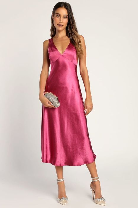 model showcasing a vibrant magenta satin dress