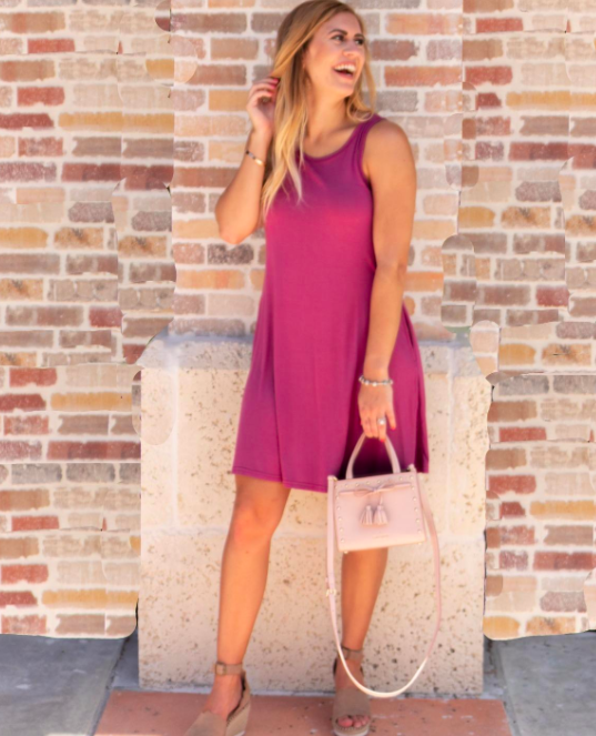 reviewer wearing the mauve dress that falls above the knee