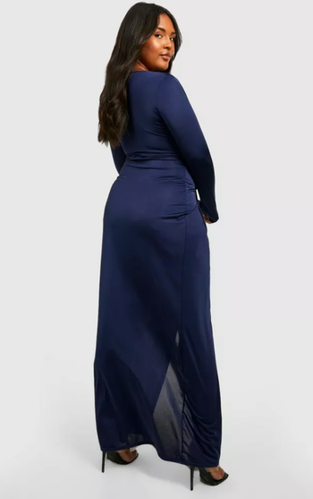 Same model showing the back view of the navy dress