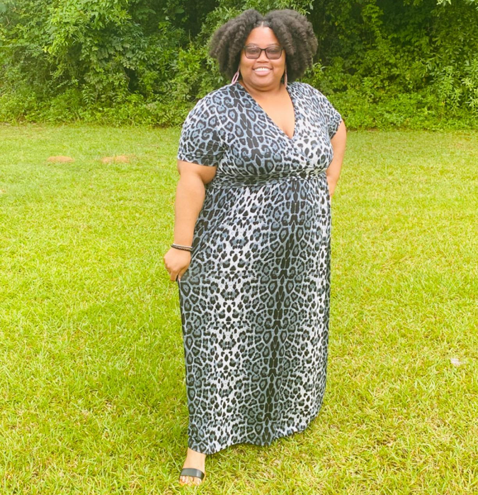 Reviewer in an animal print maxi dress