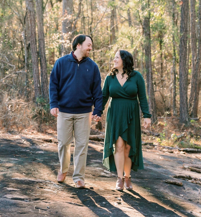 The reviewer is showcasing the same dress in a dark green color.