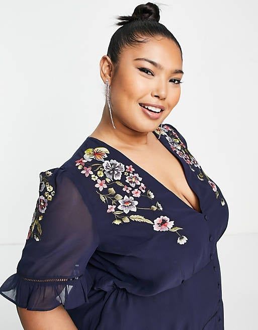Close-up view of the elegant sheer sleeves, with ruffle details and intricate lattice work on the bodice and sleeves, showcasing delicate embroidery.