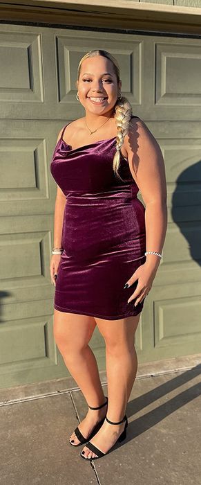 Reviewer showcasing the purple velvet dress in an XXL size