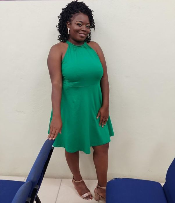 Reviewer wearing a green version of the dress