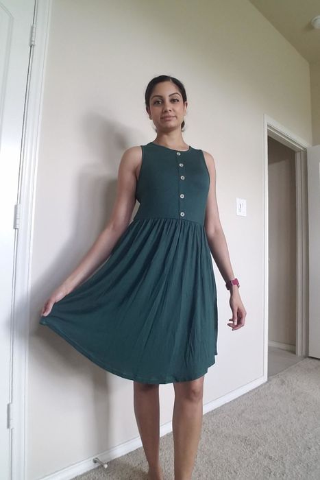 A reviewer modeling the green dress