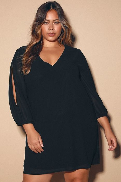 model wearing a sleek black long sleeve shift dress