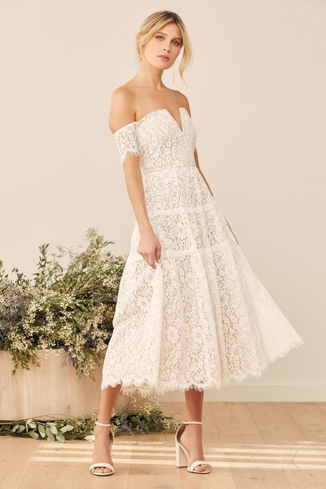 model wearing a chic white lace off-the-shoulder midi dress