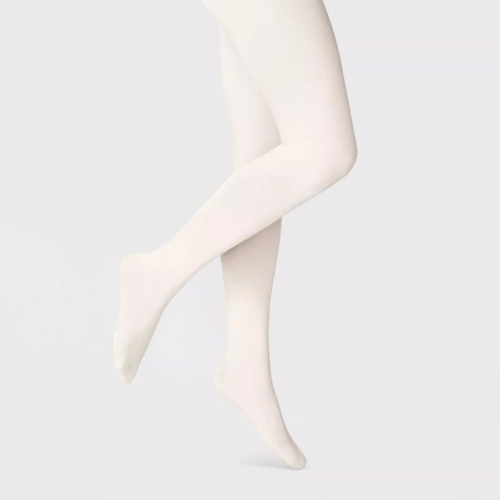 Person wearing opaque tights, shown from the waist down, in a shopping context