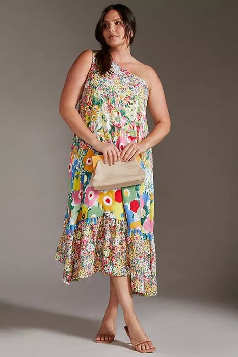model wearing a loose, colorful floral dress