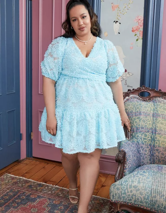 model wearing a light blue mini dress adorned with floral appliqué
