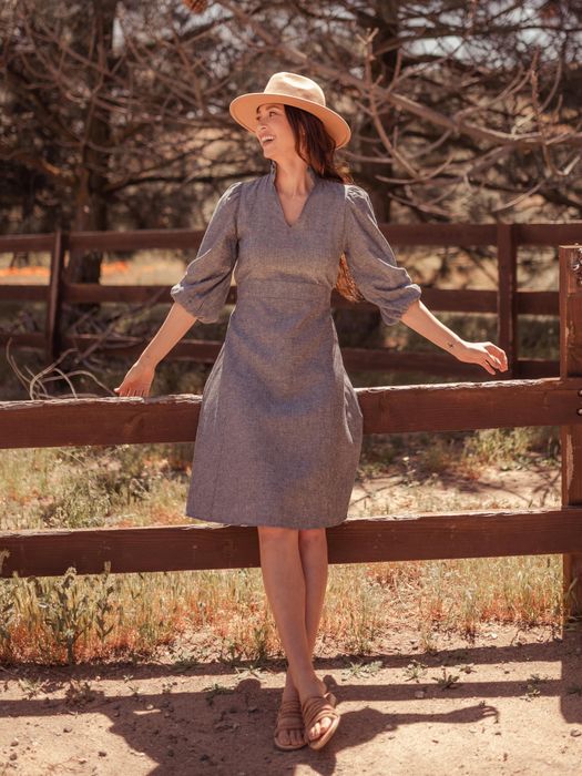 A model wearing the Sodalin Hemp Midi Dress, styled with a hat and sandals