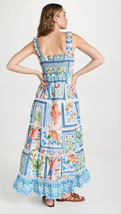 A model is shown from the back, revealing the same tropical tile print as the front.
