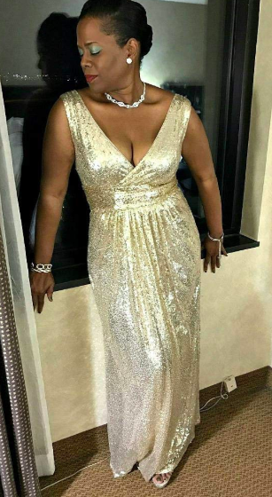 A reviewer modeling the same gown in a stunning gold hue